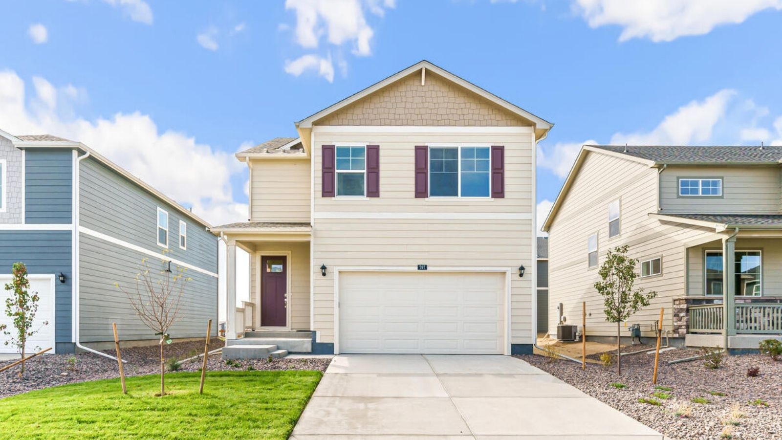 Front exterior of the Elder floor plan featuring modern architecture, professional landscaping, and a two-car garage.