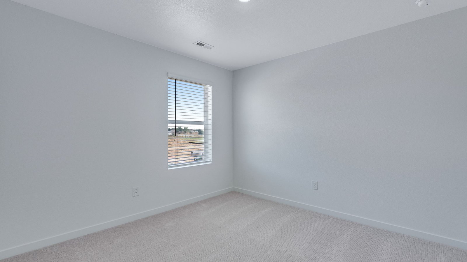 Bright secondary bedroom with convenient access to shared living spaces.
