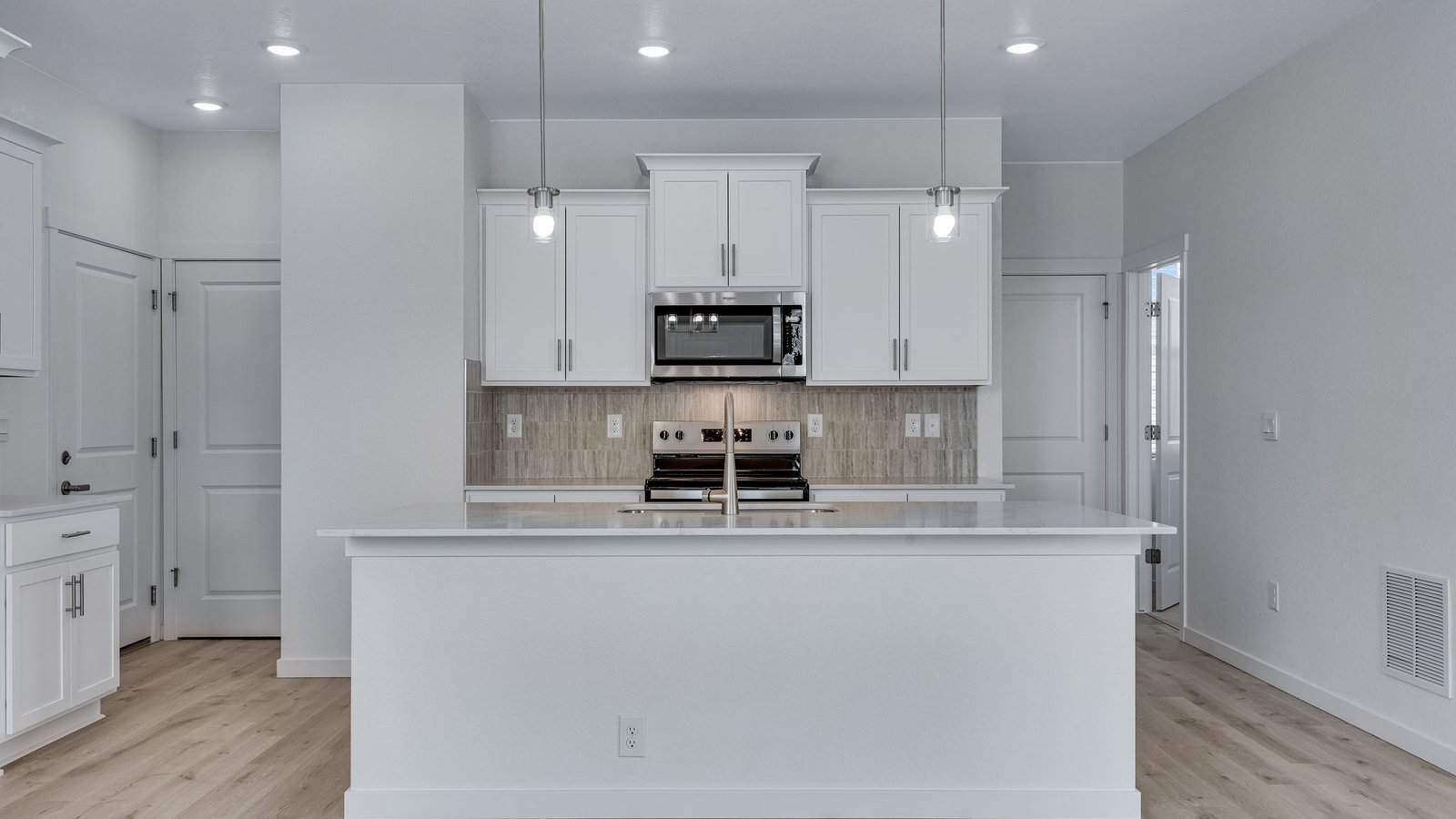 Oversized kitchen island offering additional seating, storage, and food preparation space.