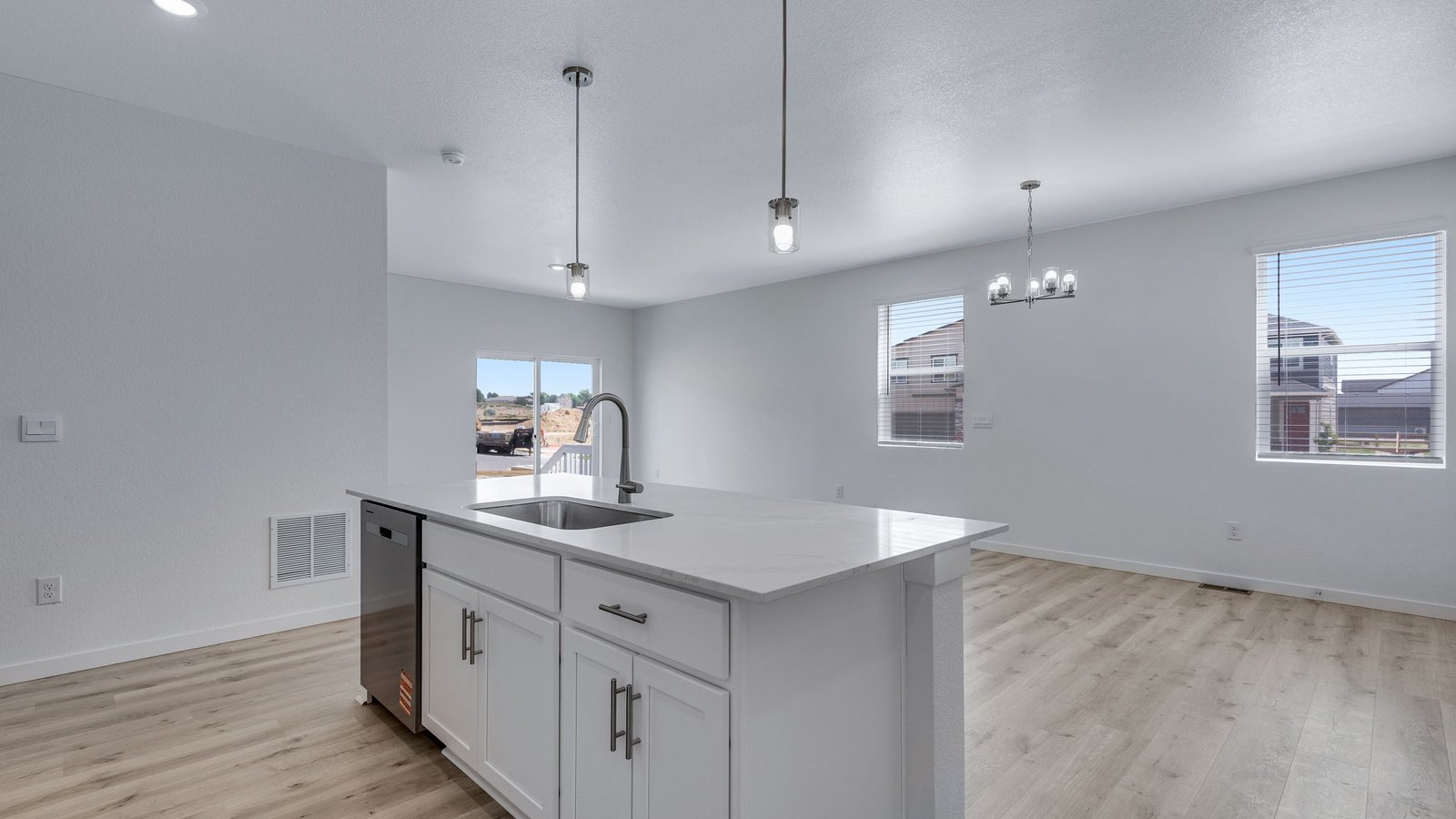 Open-concept kitchen with abundant storage, workspace, and convenient flow to the dining area.