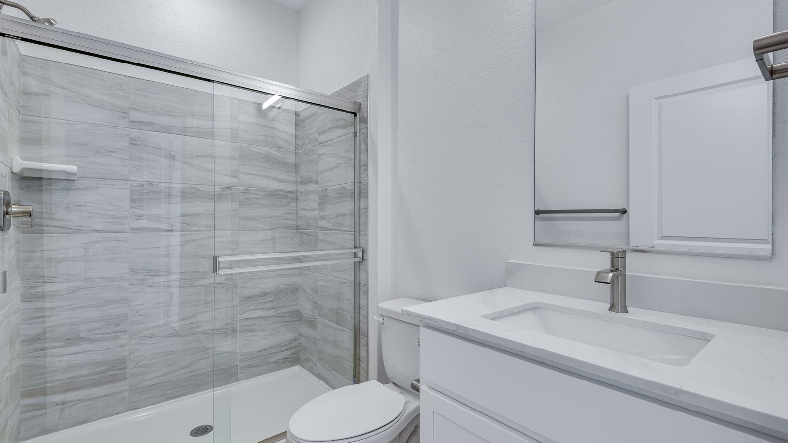 Secondary bedroom with closet storage and natural light in the Elm floor plan.