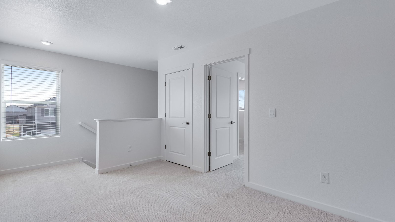 Versatile second-floor loft ideal for a media room, study area, or playroom.
