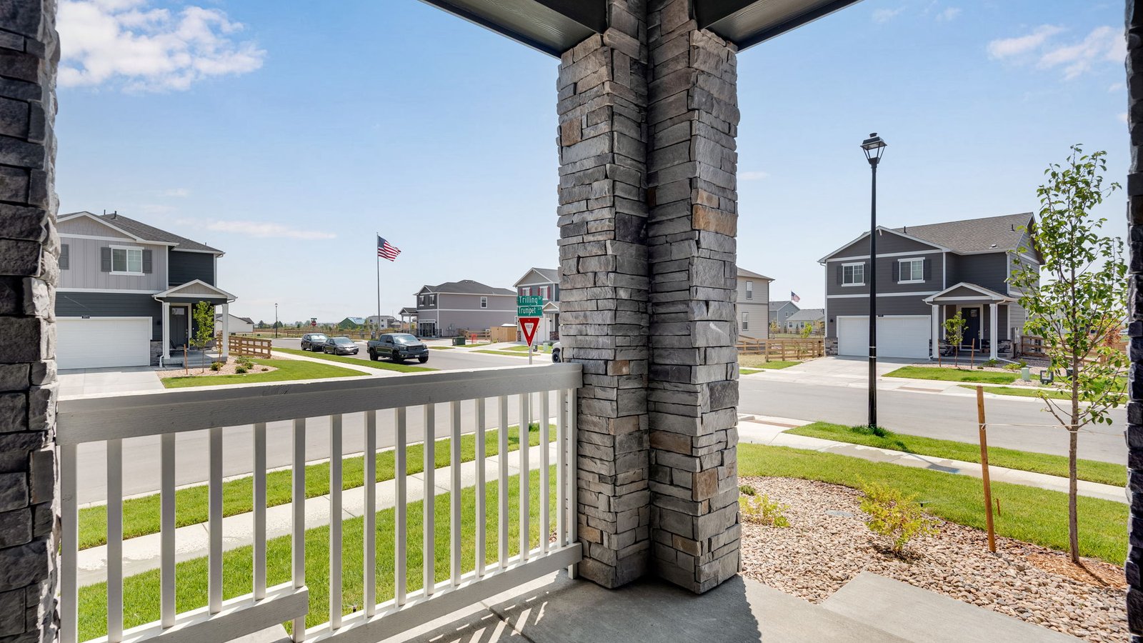 Covered front porch creating a welcoming entrance to the Elm home.