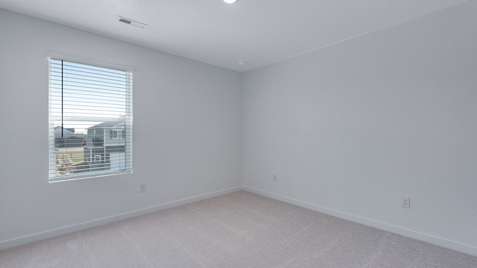 Secondary bedroom with closet storage and natural light in the Elm floor plan.