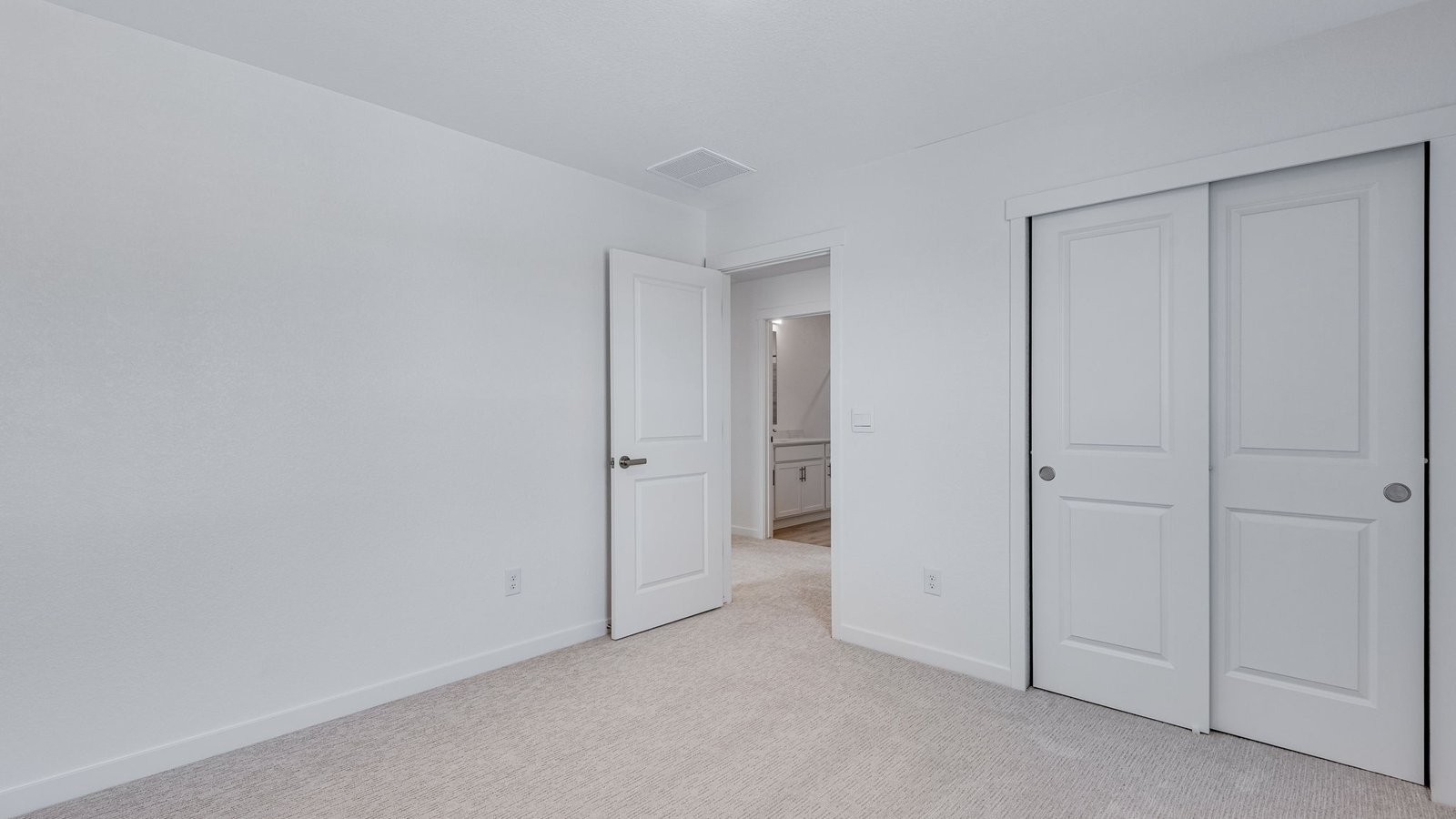 Additional bedroom featuring ample room for furniture and storage.