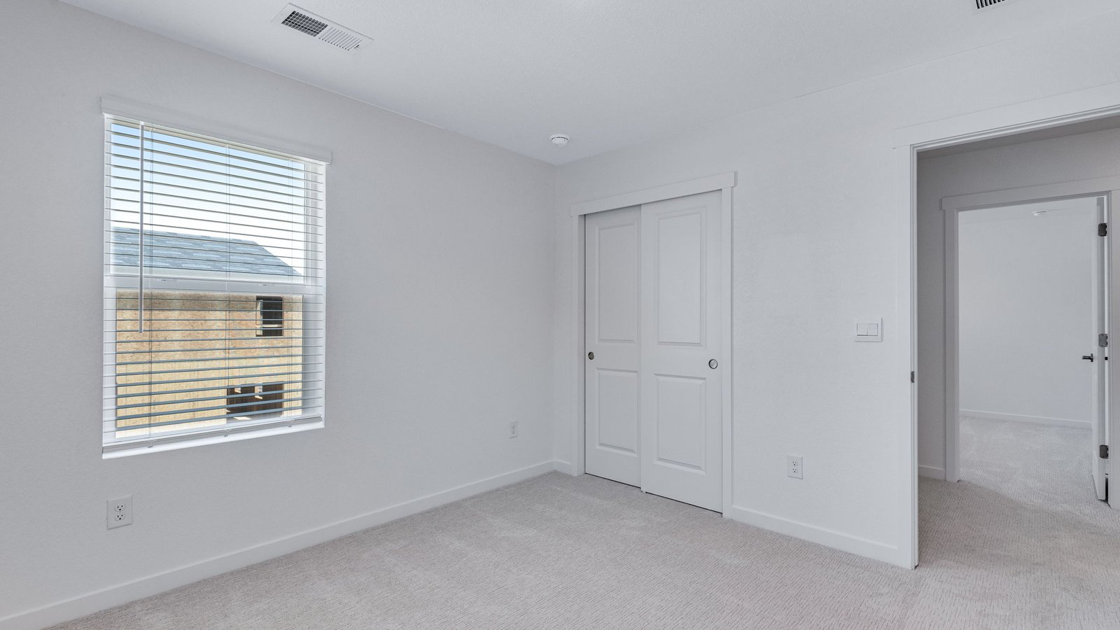 Bright secondary bedroom with convenient access to shared living spaces.