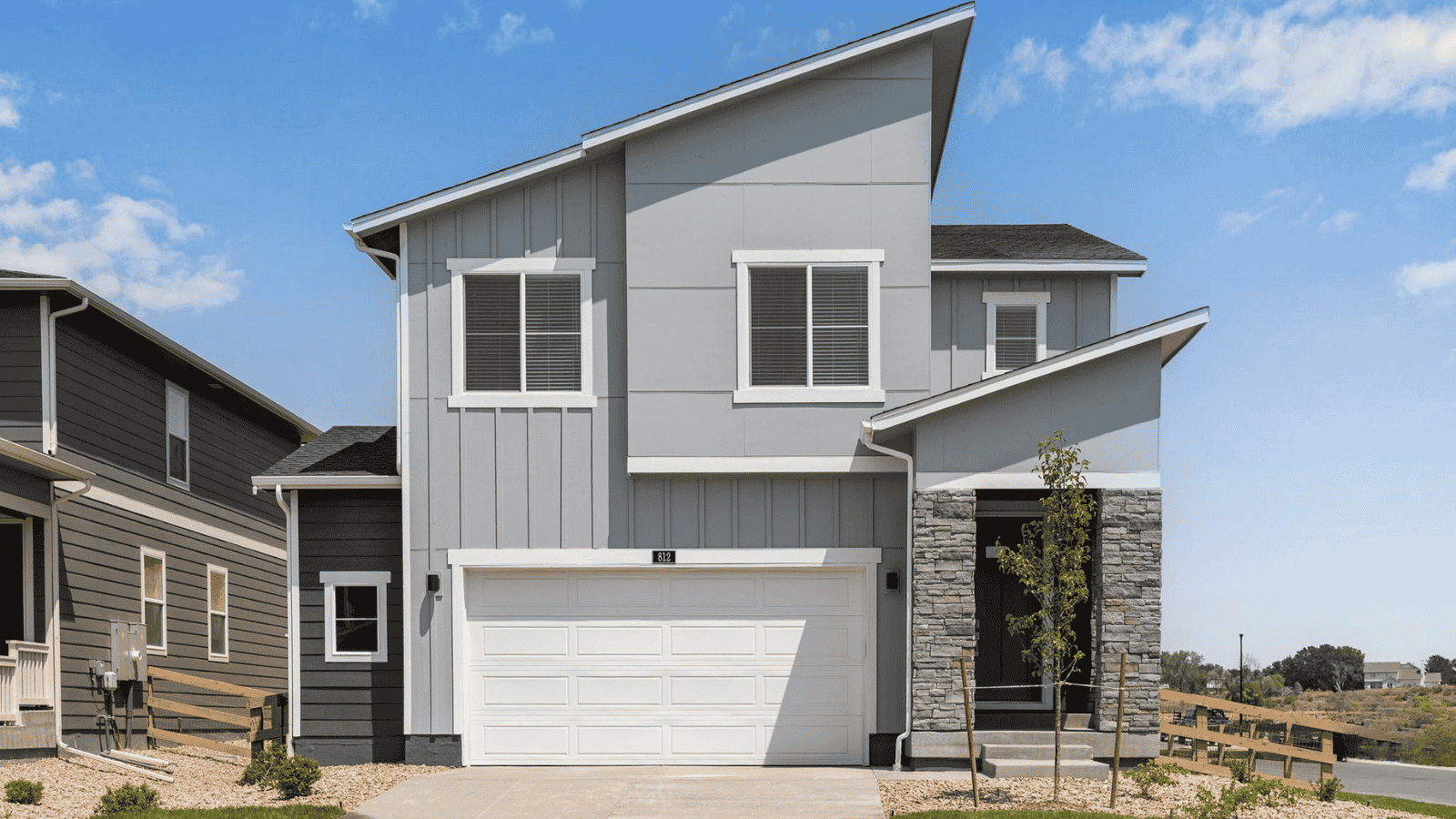 Exterior view of the Elm floor plan in Prairie Song featuring a two-story design, professional landscaping, and inviting curb appeal.