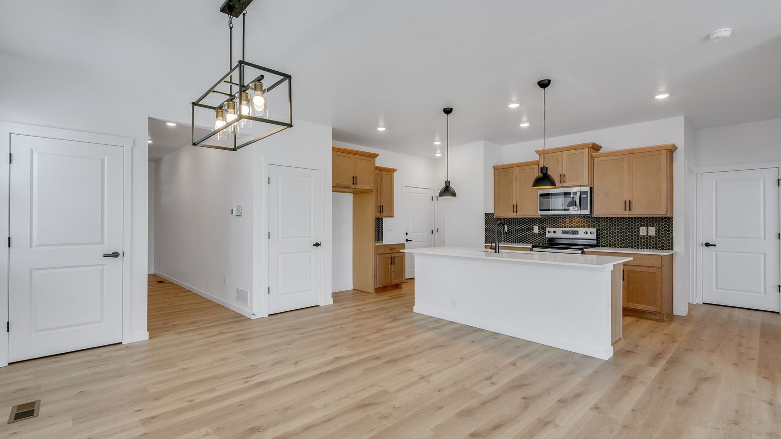 Open-concept great room in the Elm floor plan with abundant natural light and spacious seating area.