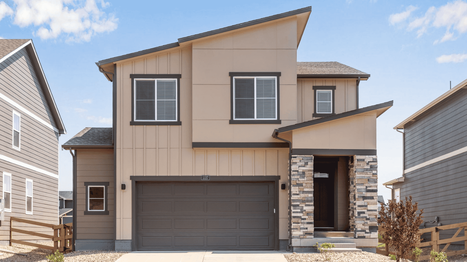 Front exterior of the Elm floor plan at Prairie Song in Windsor, Colorado, featuring professional landscaping and a welcoming front porch.