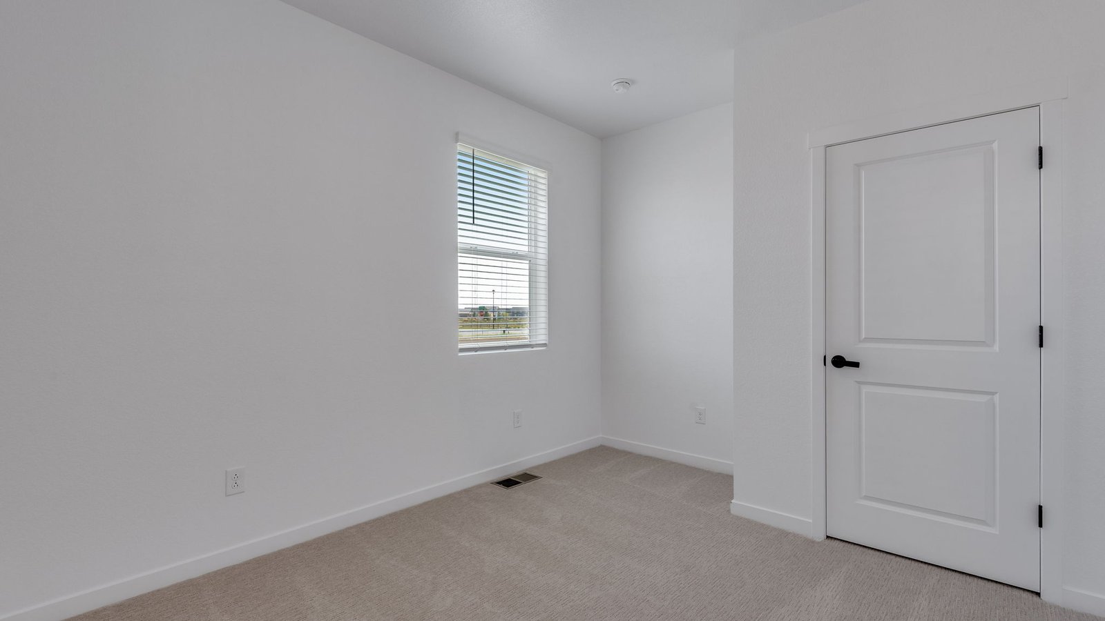 Main-floor bedroom offering flexible space for guests, family, or a home office.