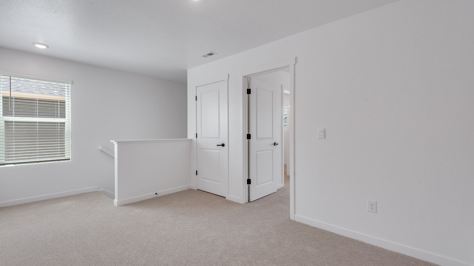 Open loft area ideal for a media room, playroom, or home office.