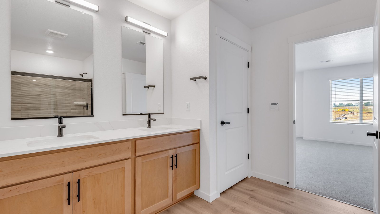 Deluxe four-piece primary bathroom with dual vanity and modern finishes.