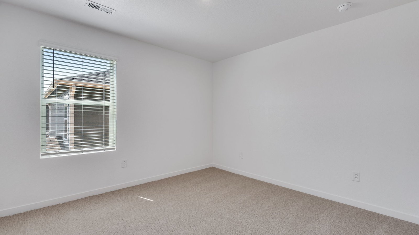 Secondary bedroom with natural light and versatile living space.