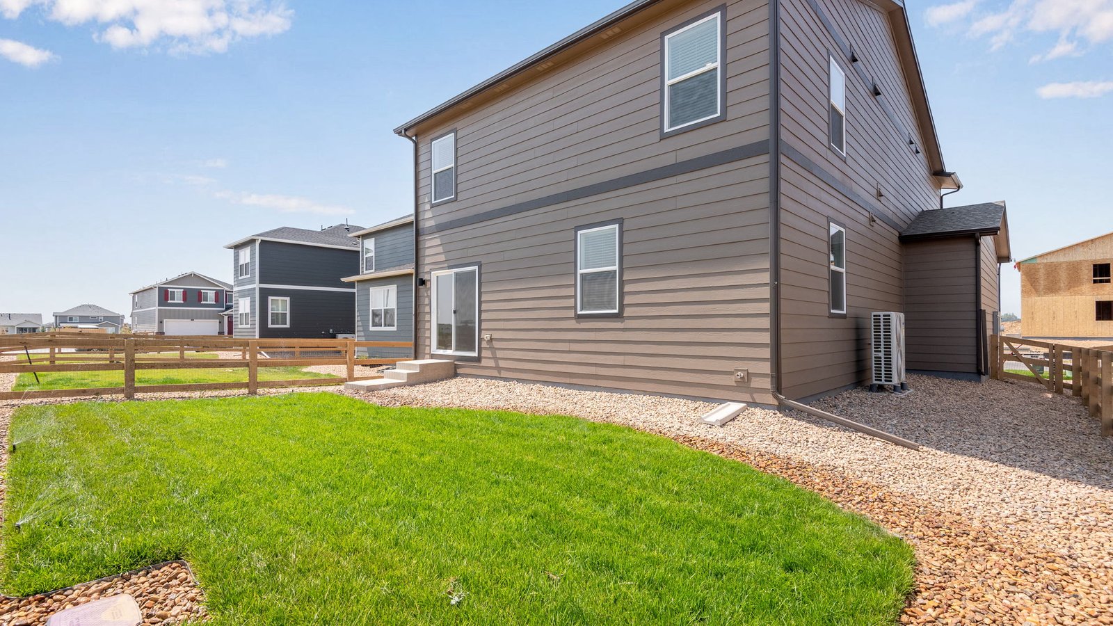 Backyard of the Elm home featuring professional landscaping and outdoor living space.