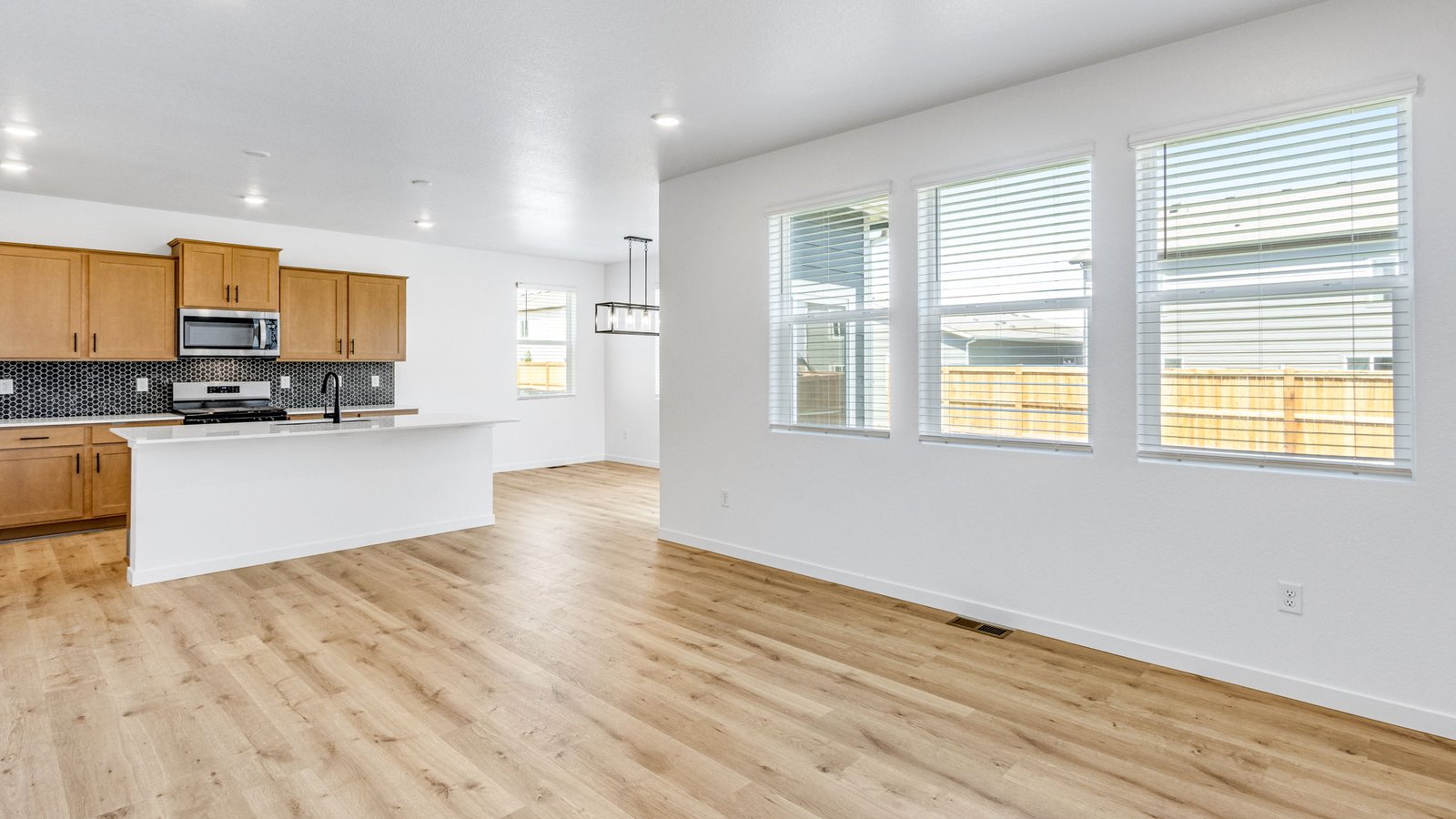 Spacious great room in the Edmon home featuring neutral finishes and an open layout for everyday living.