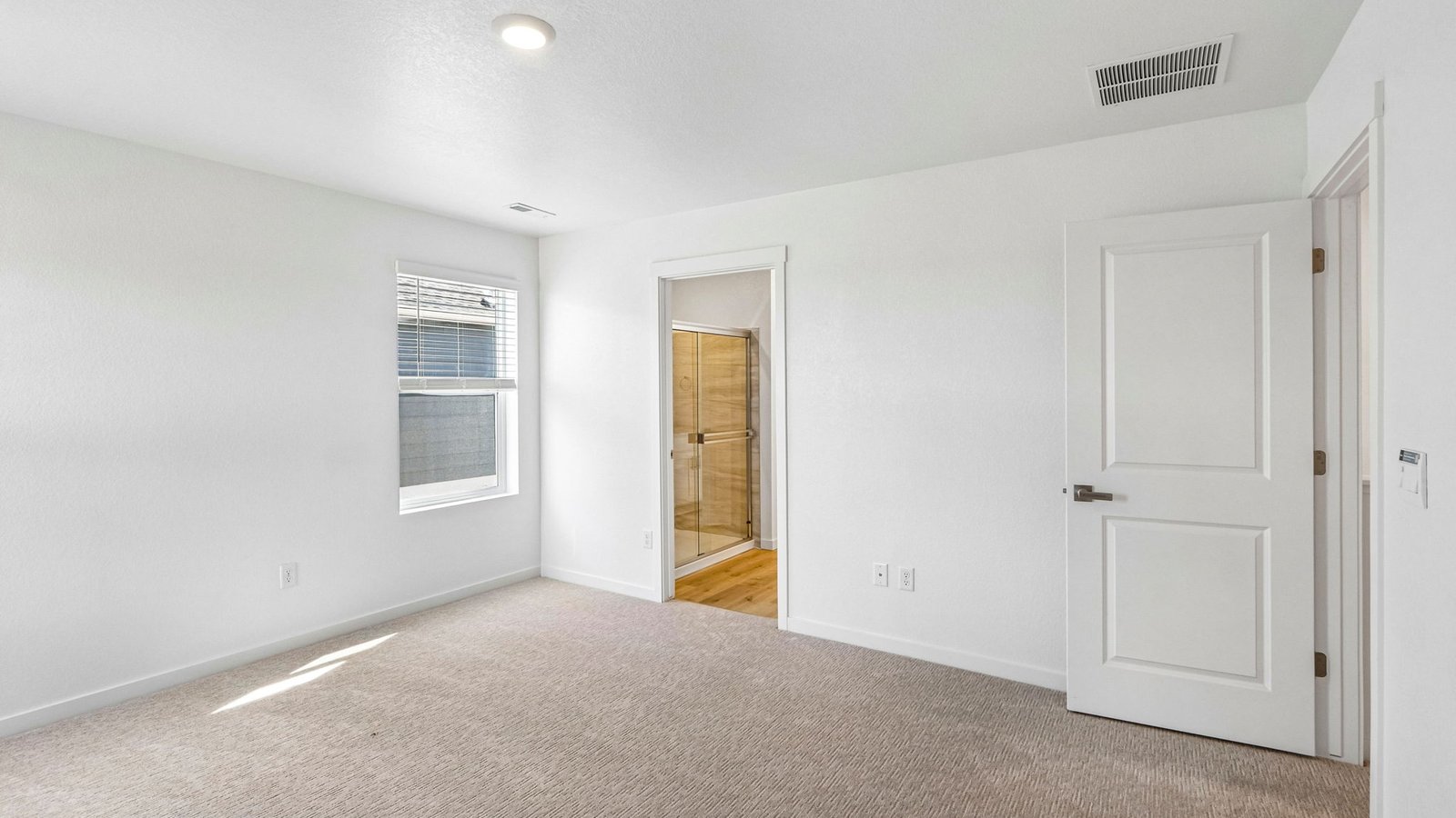 Spacious primary bedroom with large windows in new home build Edmon floor plan