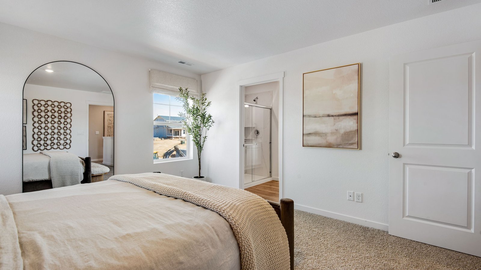Bright owner's bedroom featuring comfort, privacy, and generous space.