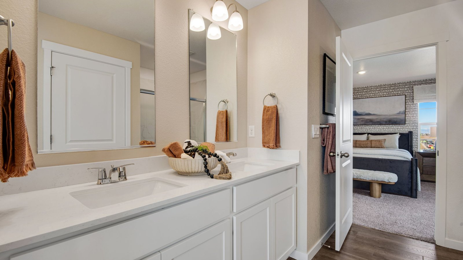 Designer-inspired primary bathroom with dual vanities and modern finishes.
