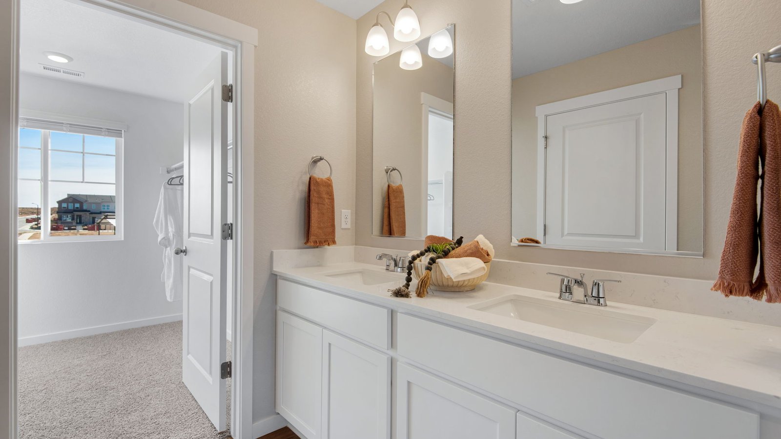 Owner's bathroom featuring dual sinks and contemporary style.