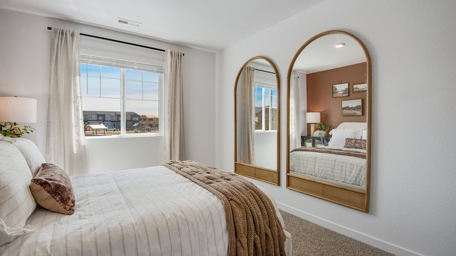 Spacious upstairs bedroom featuring natural light and comfortable living space.