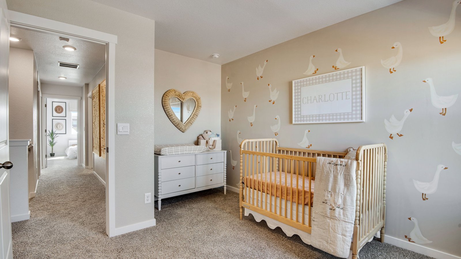 Spacious upstairs bedroom featuring natural light and comfortable living space.