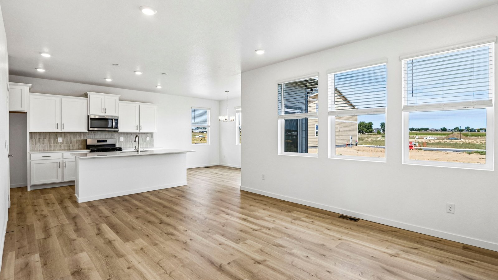 Open concept layout with large windows in new home at Granary