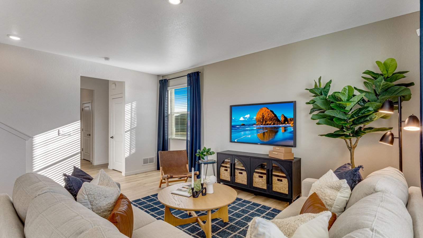 Bright and open living room in The Pine featuring large windows and abundant natural light.