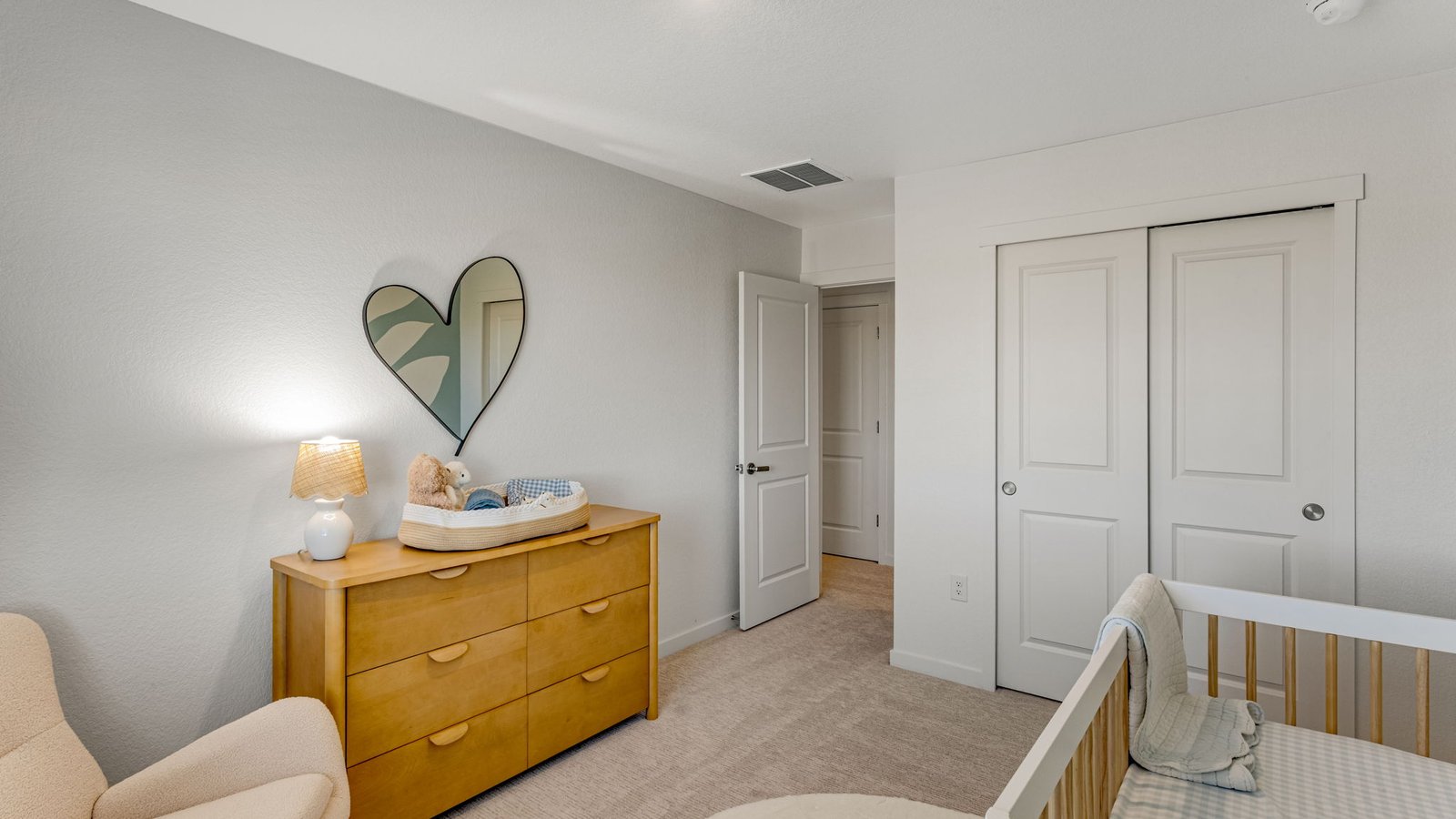 Bright upstairs bedroom featuring a versatile layout and ample closet space.
