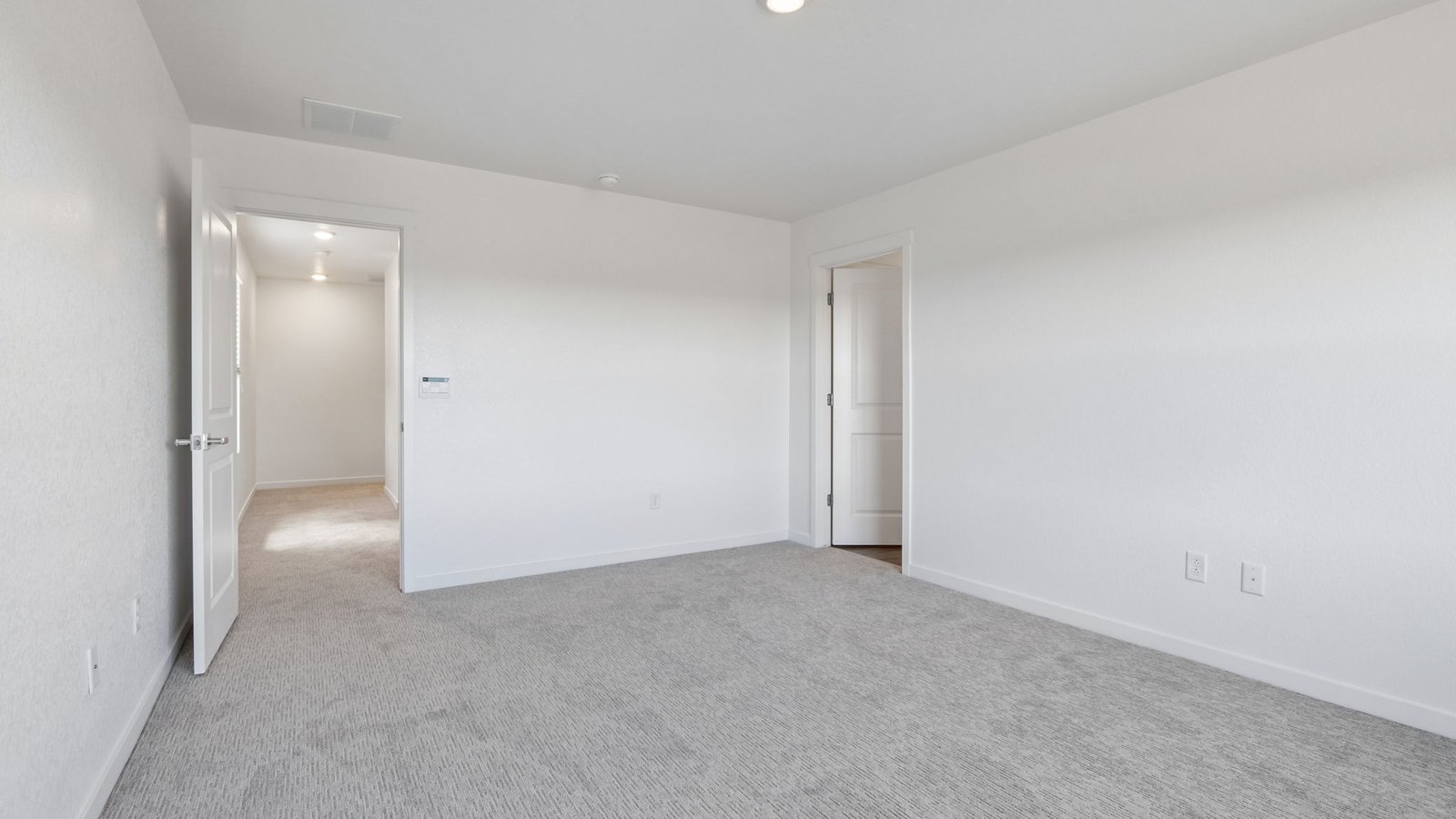 Spacious primary bedroom designed as a relaxing private retreat.