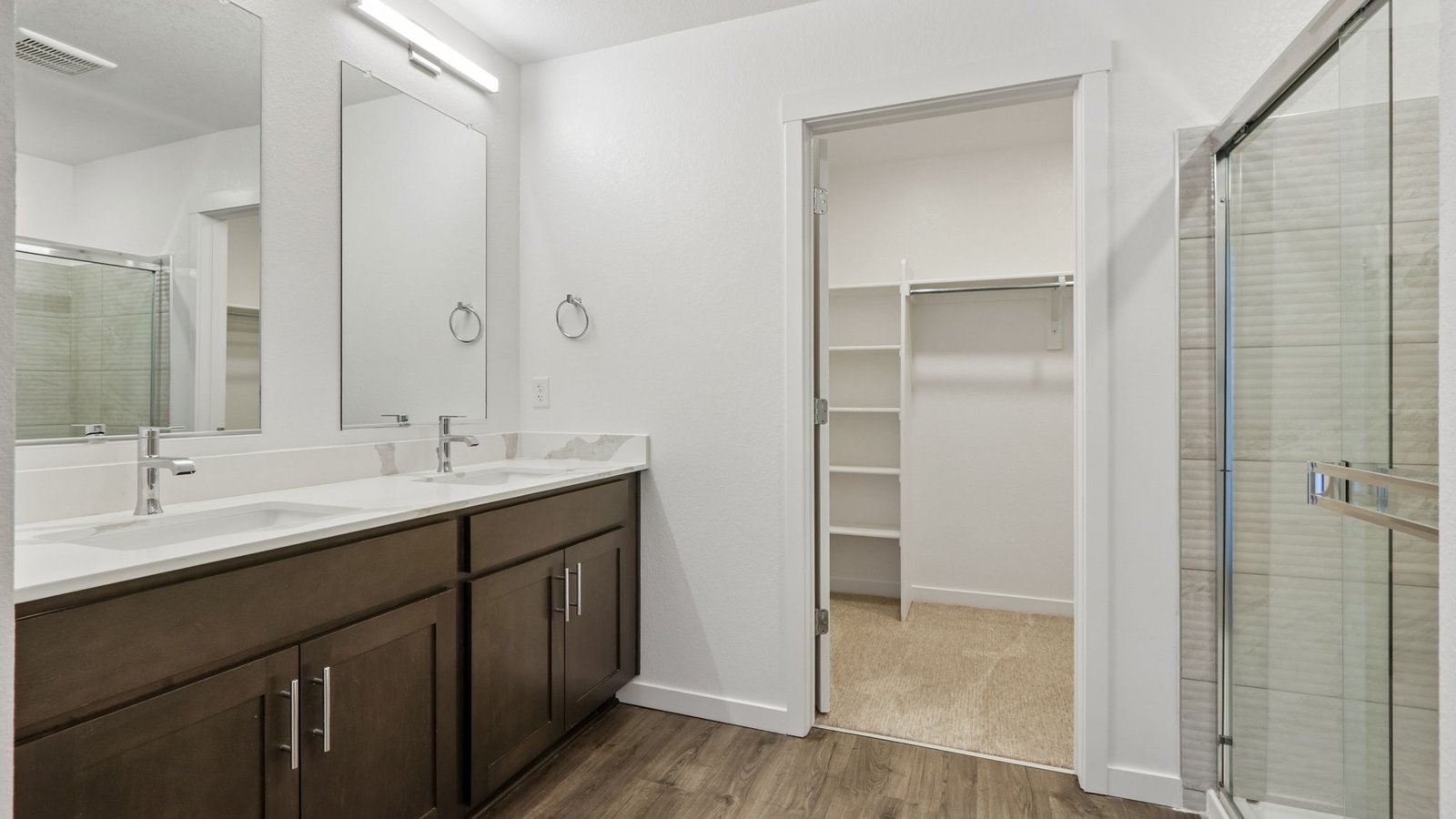 Owner's bath featuring dual vanities, a private water closet, and spacious design.