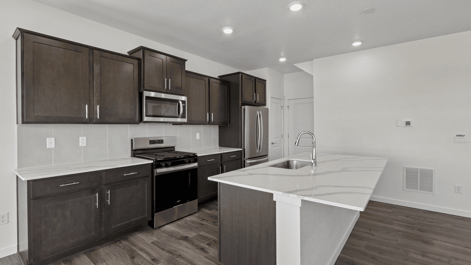 Modern kitchen in The Pine featuring ample counter space and stylish finishes.