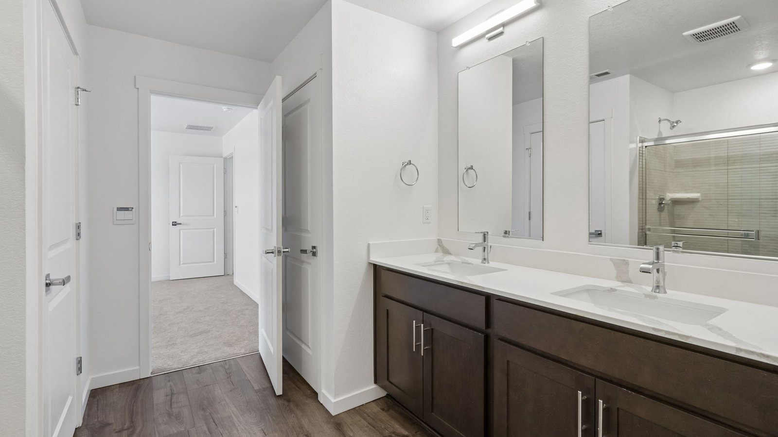 Primary bath with dual vanities and thoughtful storage solutions.
