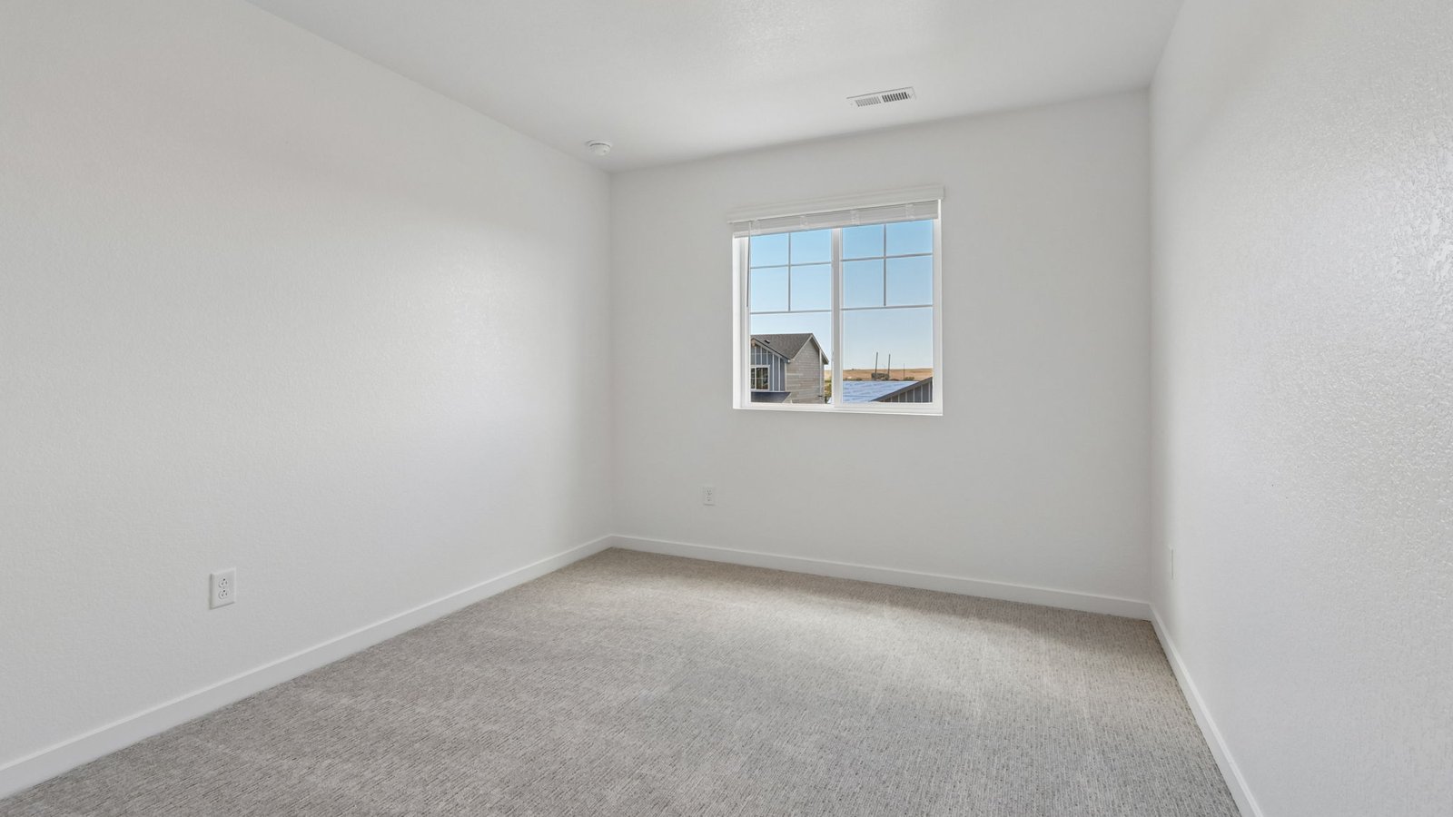 Comfortable secondary bedroom with natural light and flexible living space.