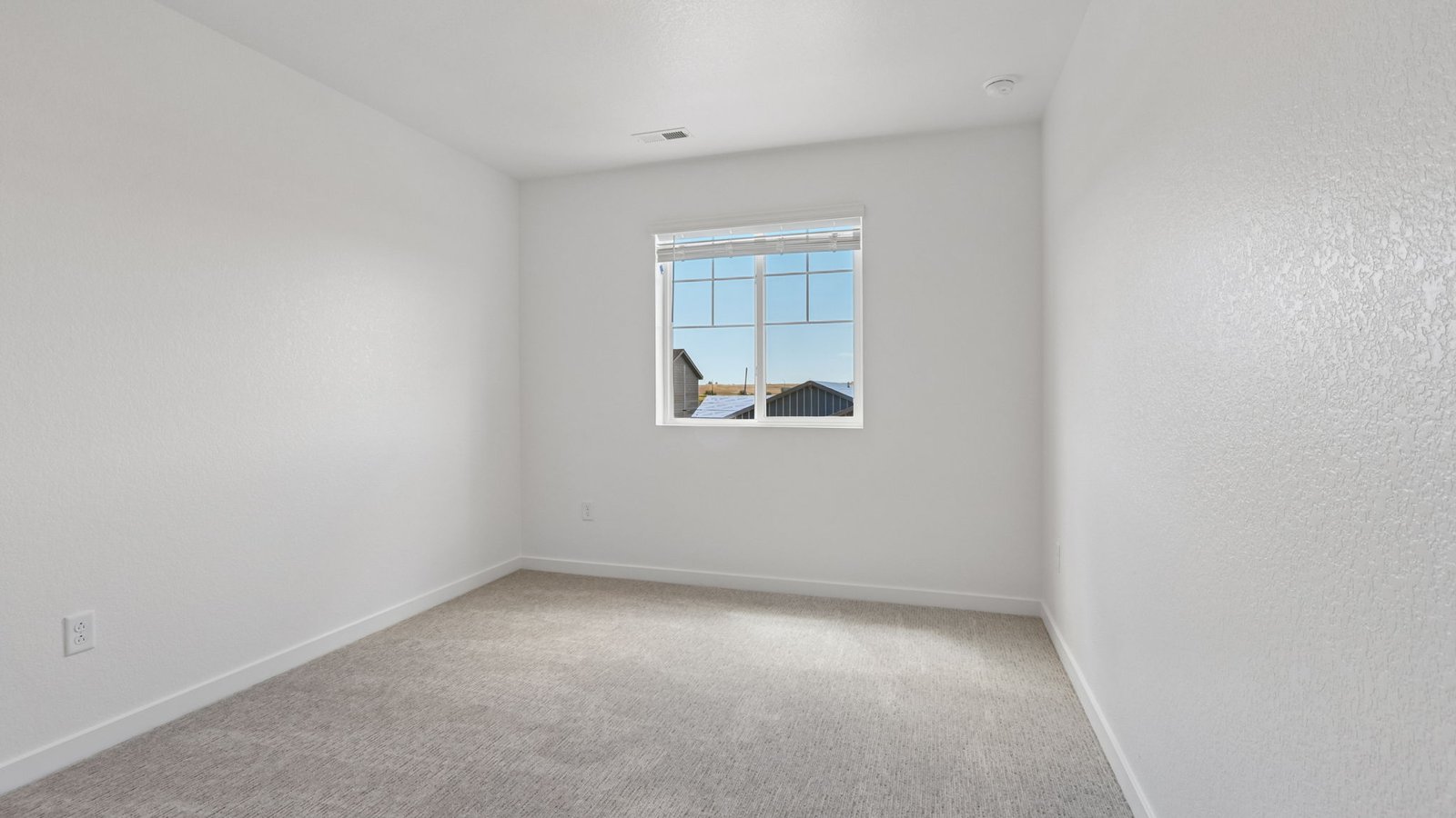Well-sized bedroom perfect for guests, family members, or a home office.