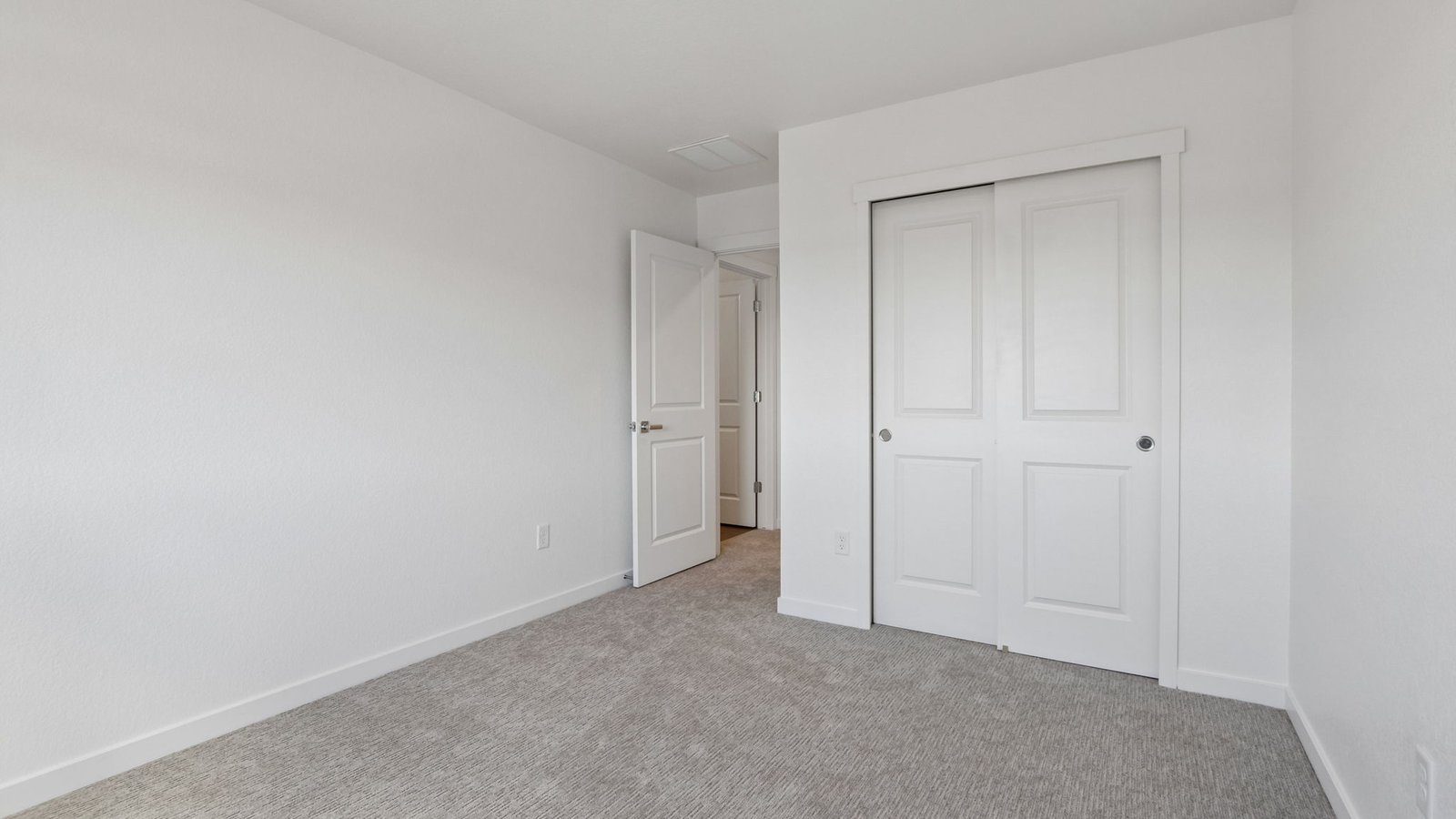 Bright upstairs bedroom featuring a versatile layout and ample closet space.