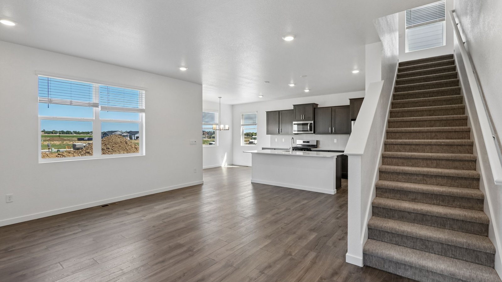 Spacious great room with open-concept design connecting seamlessly to the kitchen and dining area.