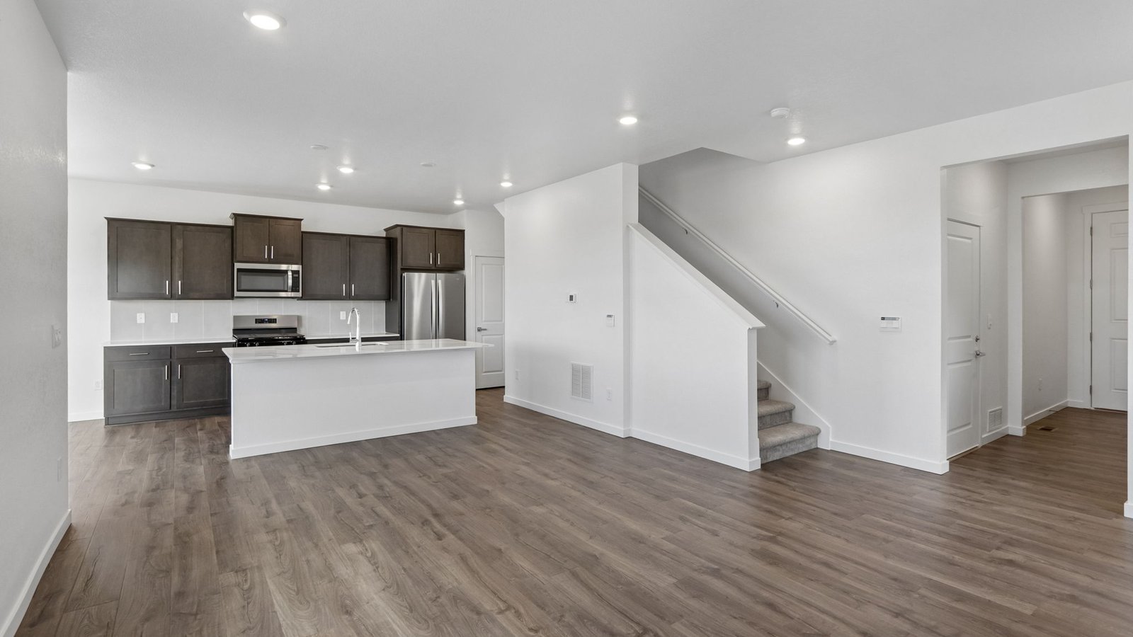 Gourmet kitchen with stainless steel appliances, large island, and walk-in pantry.