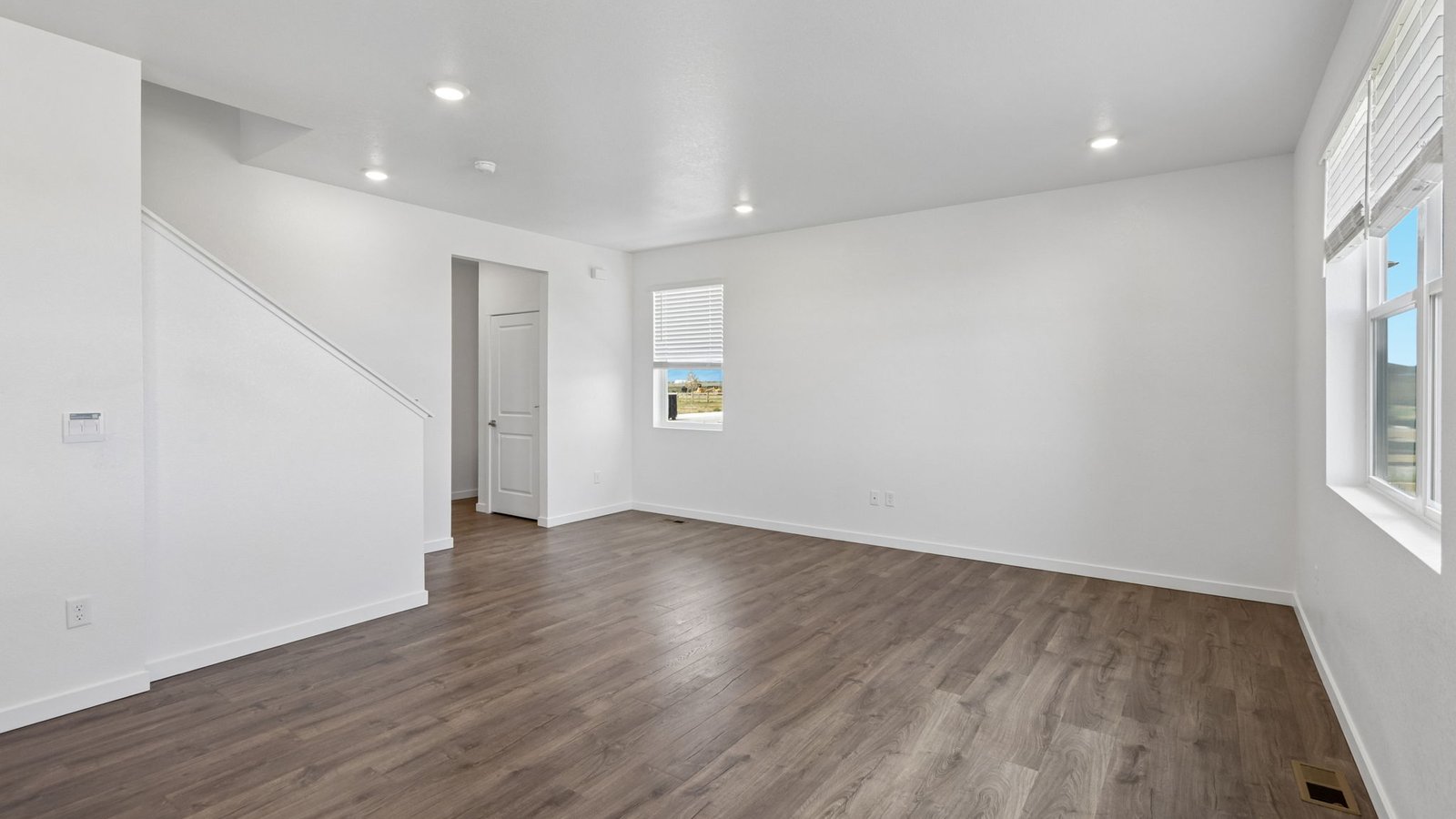 Bright and open living room in The Pine featuring large windows and abundant natural light.