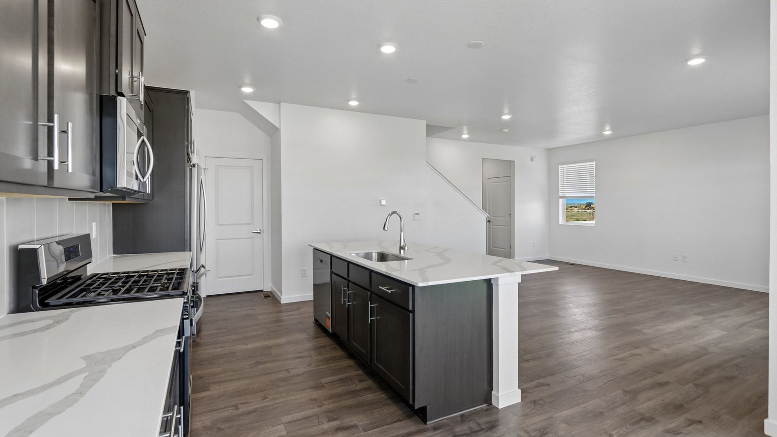 Functional kitchen offering generous storage, modern finishes, and a central gathering island.