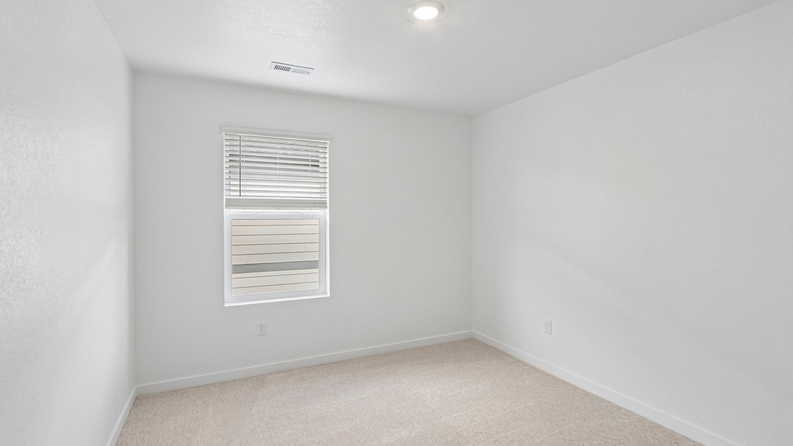 Secondary bedroom with large windows in new home at Granary Community