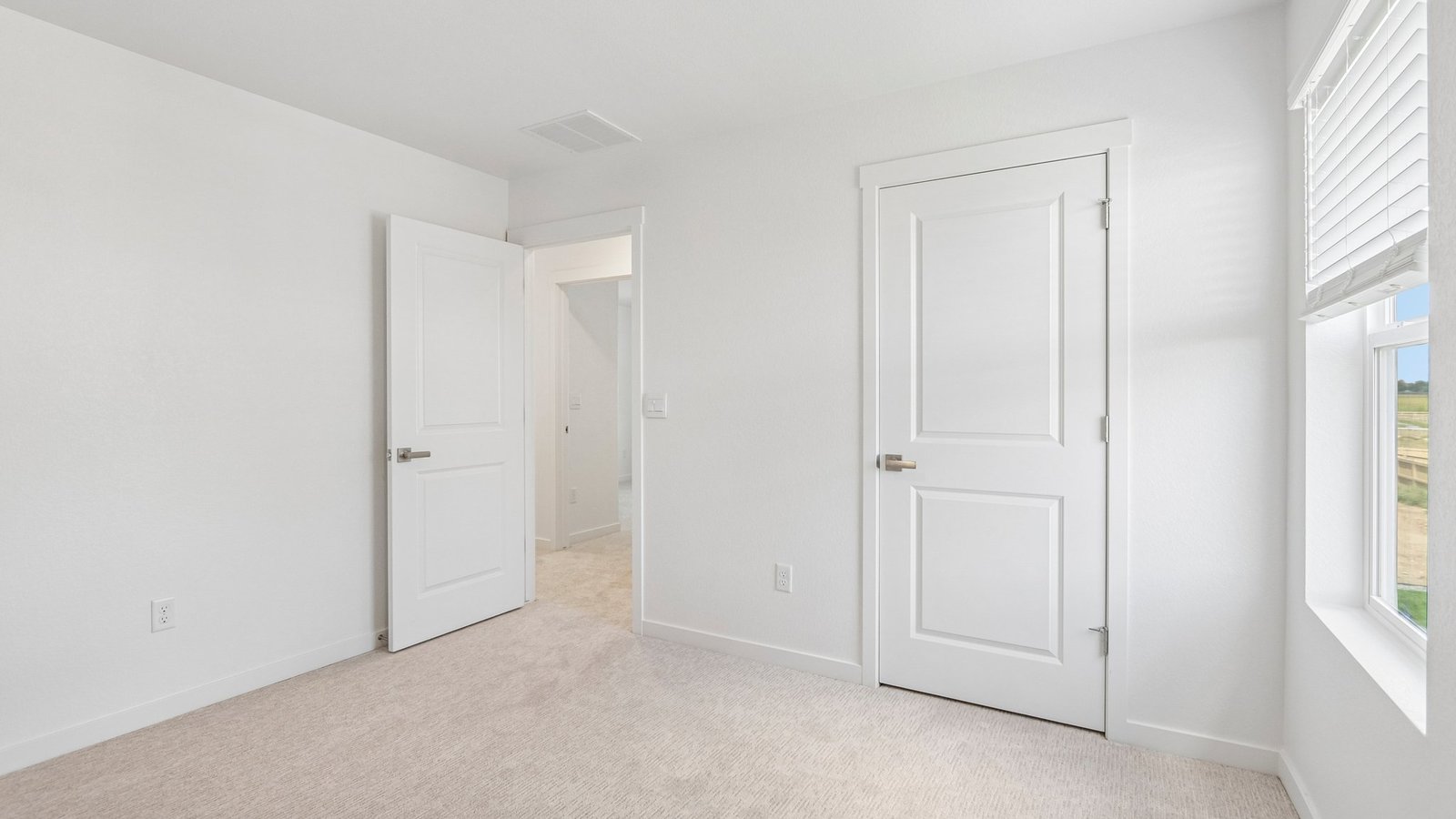 Secondary bedroom with large windows in new home at Granary Community