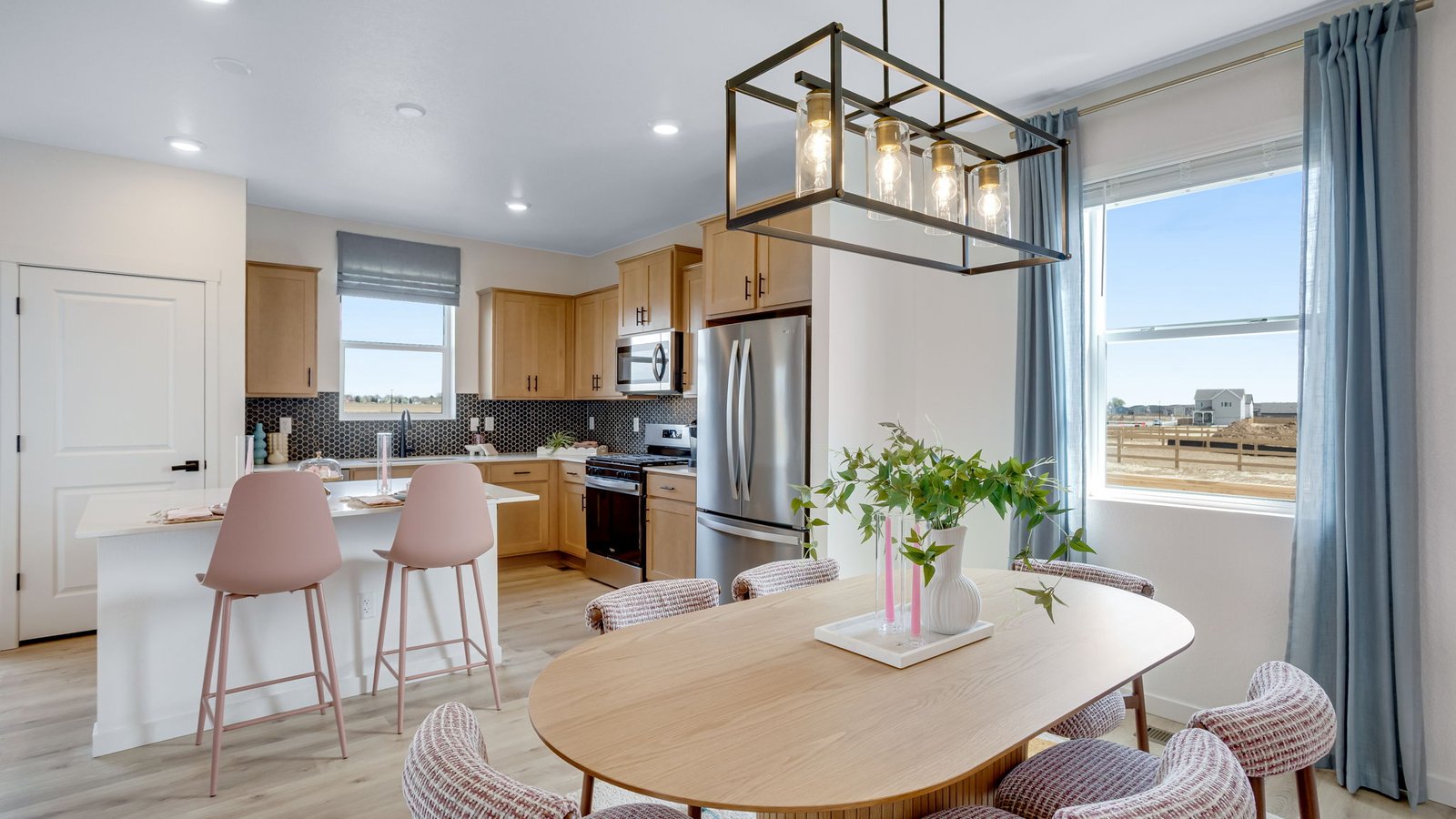 Main living area connected to kitchen and dining space in a new Granary home in Johnstown, Colorado.