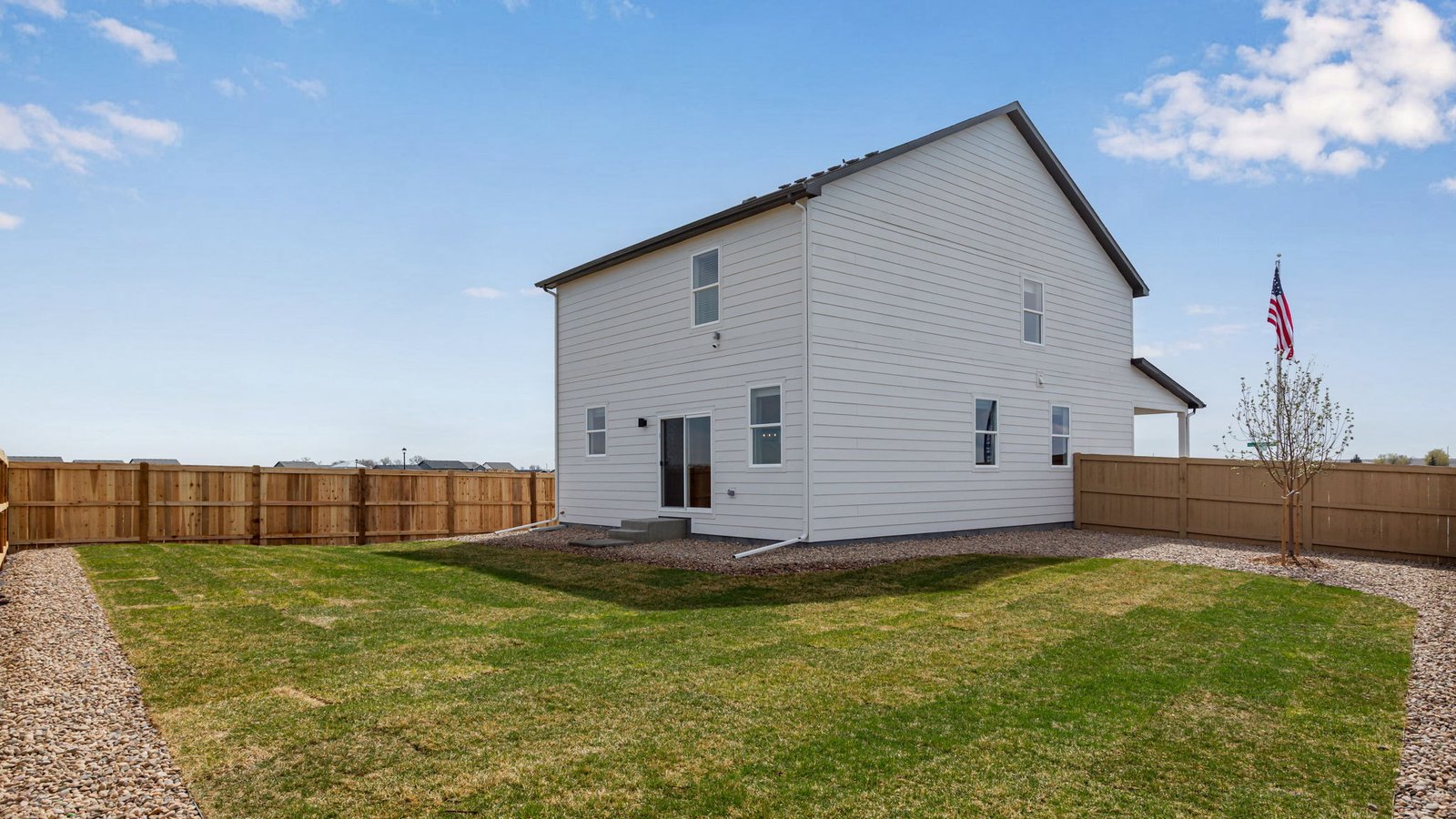 Exterior view of the Elder floorplan two‑story home with attached garage in the Granary community in Johnstown, Colorado.