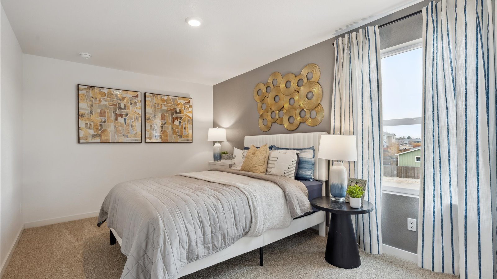 Secondary bedroom with large window in new D.R. Horton home in Brighton, Colorado
