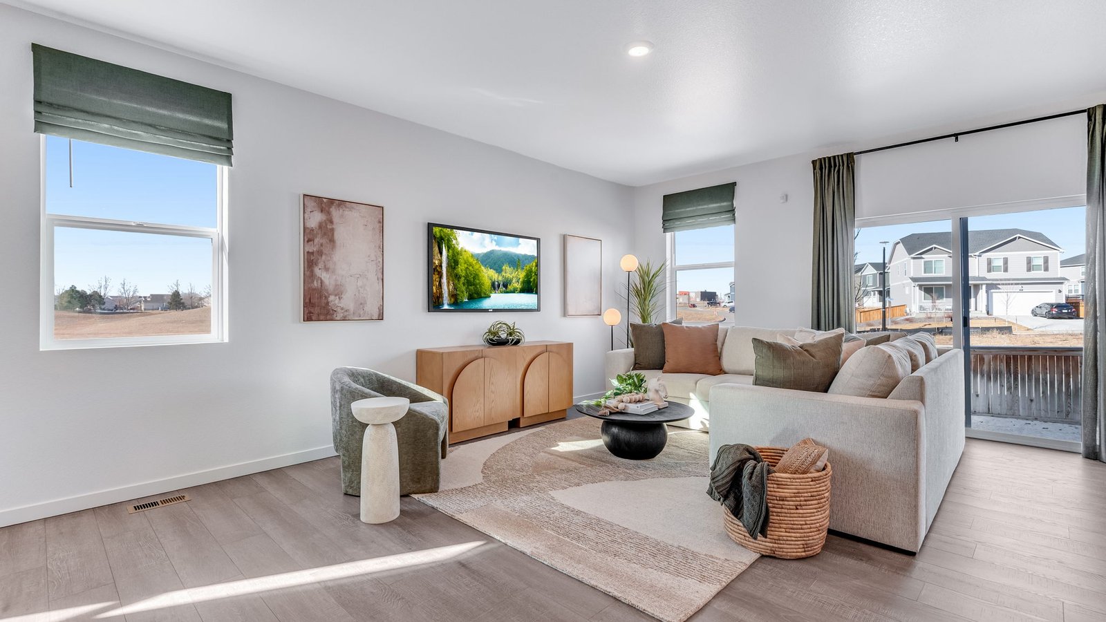 Living room with large windows in new D.R. Horton home in Lochbuie, Colorado