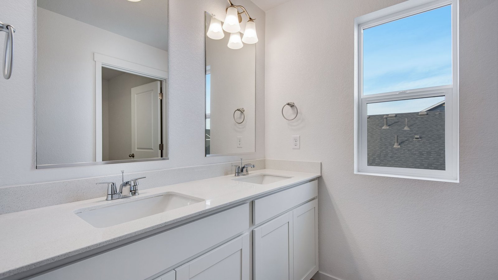 Secondary bathroom with dual vanity sinks in new D.R. Horton home in Brighton Colorado