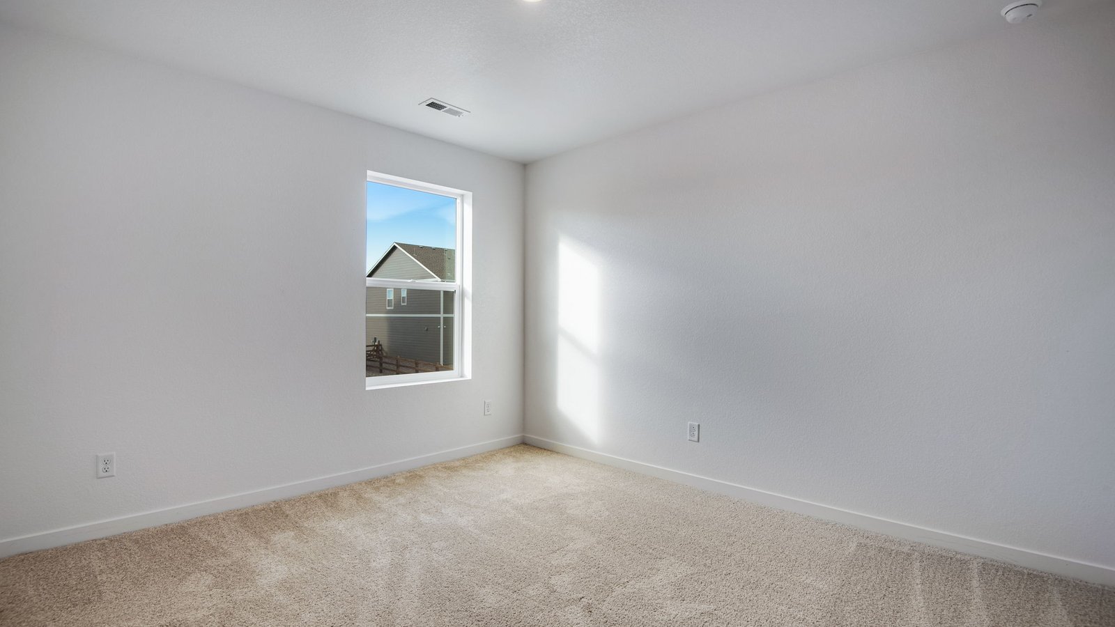 Secondary bedroom with large windows near Brighton Colorado