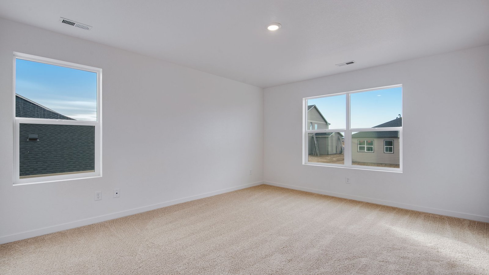 Spacious Primary bedroom with large windows in new home community Silver Peaks