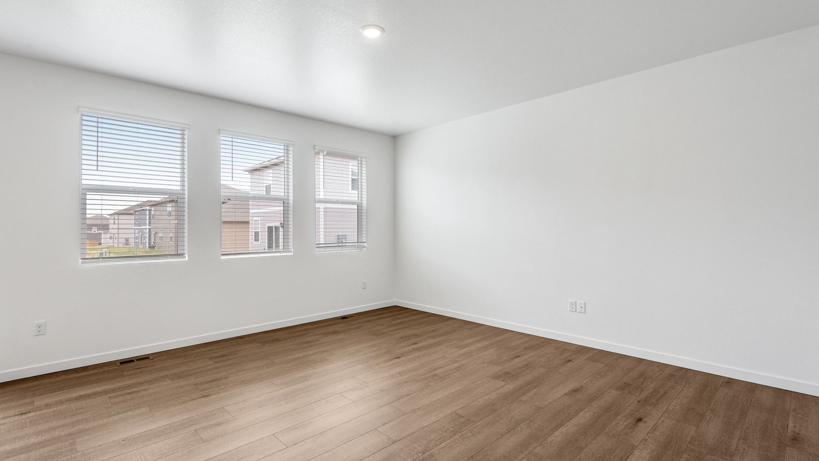 Living room with large windows in new home in Lochbuie Colorado