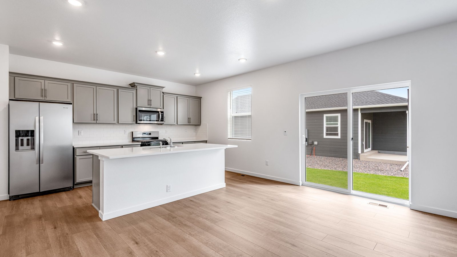 Kitchen with access to the backyard at new home in Silver Peaks Community